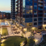 apartment building at night with landscape and lights outside