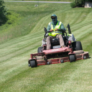 Riding mower cutting commercial property lawn